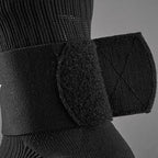A closer up of the black shin guard fixed bandage tape