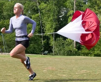 A Woman running with the drag parachute 